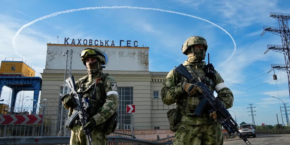 Russian troops guard an entrance of the Kakhovka Hydroelectric Station, a run-of-river power plant on the Dnieper River in Kherson region, south Ukraine, Friday, May 20, 2022.