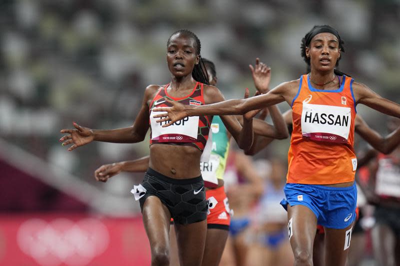 In this Friday, July 30, 2021 file photo, Sifan Hassan, of the Netherlands, right, crosses the finish line ahead of Agnes Tirop, of Kenya, left, to win a heat in the women’s 5,000-meter run at the 2020 Summer Olympics, in Tokyo. (AP Photo/Petr David Josek, File)