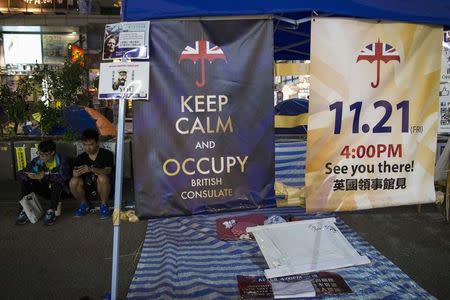 Posters appealing for people to join them for an upcoming protest, are displayed in an area protesters are occupying in Mongkok shopping district in Hong Kong November 10, 2014. REUTERS/Tyrone Siu