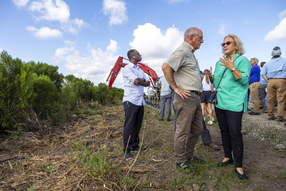 Louisiana Gov. John Bel Edwards, center, talks with former U.S. Sen, Mary Landrieu, right, at the Mid-Barataria Sediment Diversion ground-breaking ceremony south of Belle Chasse, La., Thursday, Aug. 10, 2023. Nearly $3 billion in settlement money from the BP Deepwater Horizon disaster that devastated the Gulf Coast and killed hundreds of thousands of marine animals is now funding a massive ecosystem restoration in southeastern Louisiana’s Plaquemines Parish. (Chris Grange/The Times-Picayune/The New Orleans Advocate via AP)