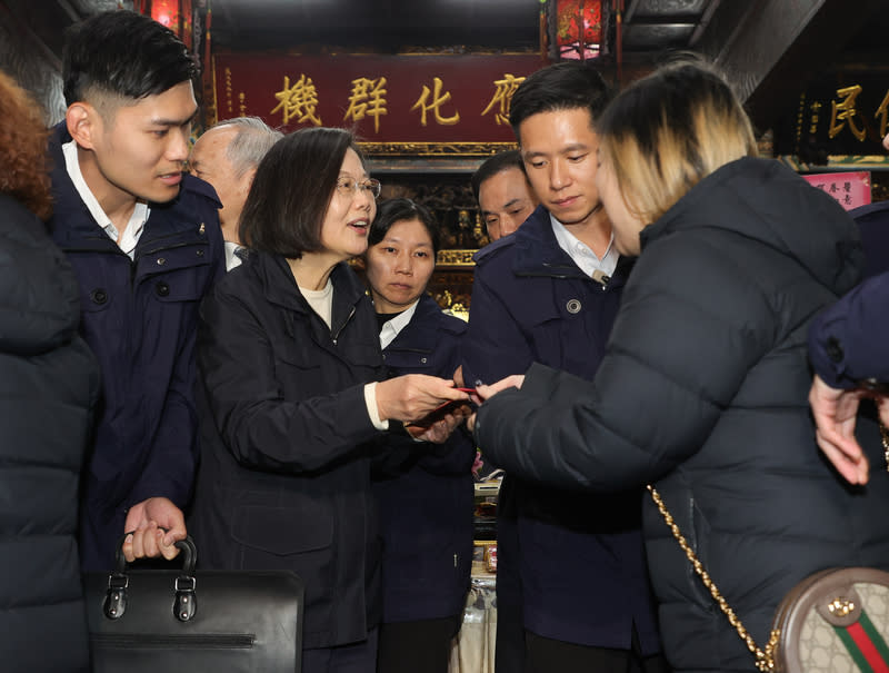 總統蔡英文（前左二）10日到台北覺 修宮參香，並發放新春福袋給民眾。 （中央社）