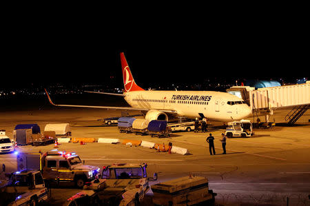 Firemen are seen entering the cargo compartment of a Turkish Airlines flight parked on the tarmac of Budapest Airport, Hungary, August 15, 2018 after one terminal of the airport and its surroundings were briefly shut down as the Disaster Management Authority ordered an investigation due to an overheated container carrying an isotope on an incoming flight. Neither the airport nor the disaster control authority confirmed that the flight affected was operated by Turkish Airlines. REUTERS/Bernadett Szabo