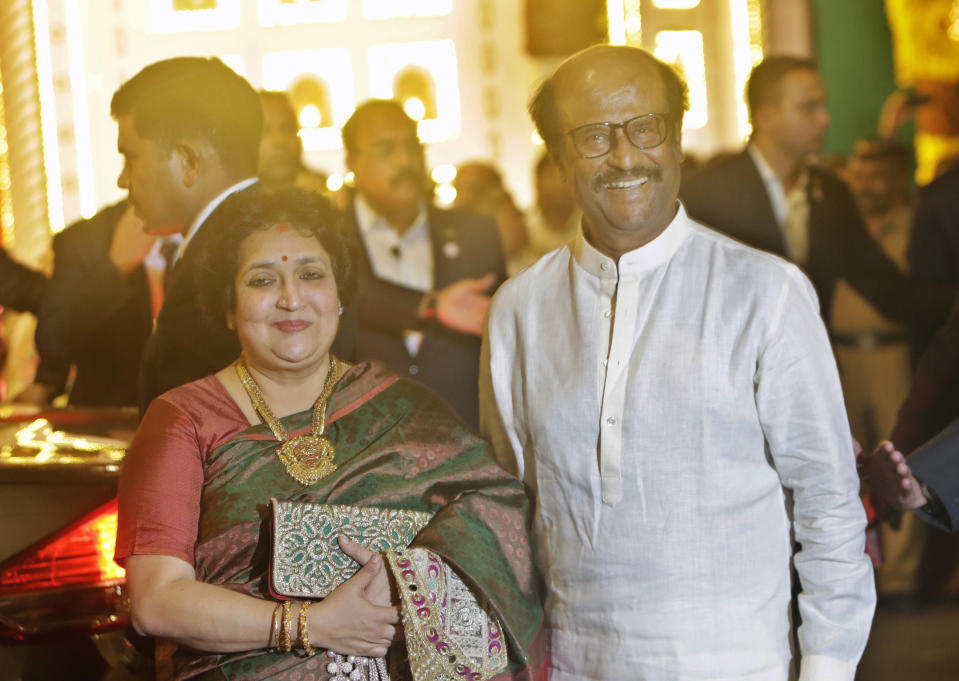 Indian superstar Rajinikanth and his wife Latha Rajinikanth arrive to attend the wedding of Isha Ambani, the daughter of Reliance Industries Chairman Mukesh Ambani, and Anand Piramal in Mumbai, India, Wednesday, Dec. 12, 2018. In a season of big Indian weddings, the Wednesday marriage of the scions of two billionaire families might be the biggest of them all. Isha is the Ivy League-educated daughter of industrialist Mukesh Ambani, thought to be India's richest man. The groom is the son of industrialist Ajay Piramal, thought to be worth $10 billion. (AP Photo/Rajanish Kakade)