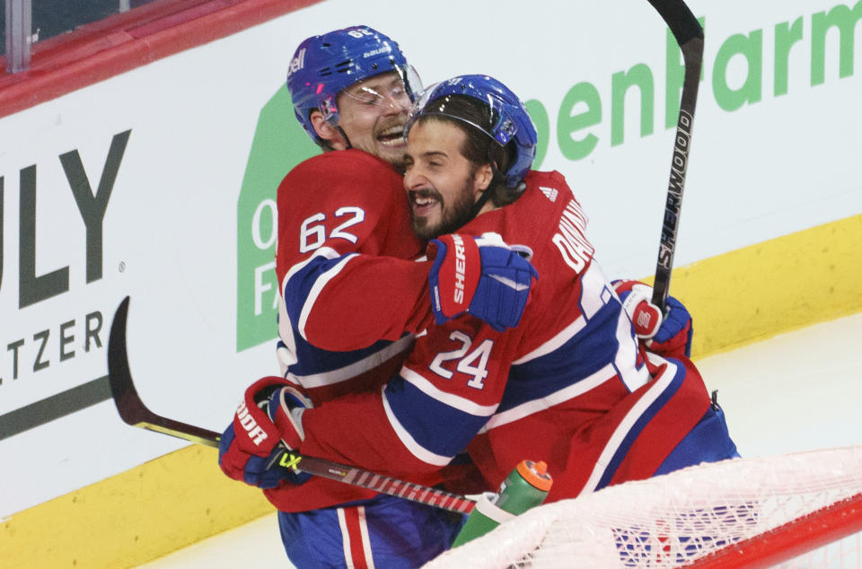 Montreal Canadiens' Artturi Lehkonen (62) celebrates his game-winning goal with teammate Montreal Canadiens' Phillip Danault (24) following overtime in Game 6 of an NHL hockey Stanley Cup semifinal playoff series against the Vegas Golden Knights Thursday, June 24, 2021 in Montreal. (Paul Chiasson/The Canadian Press via AP)