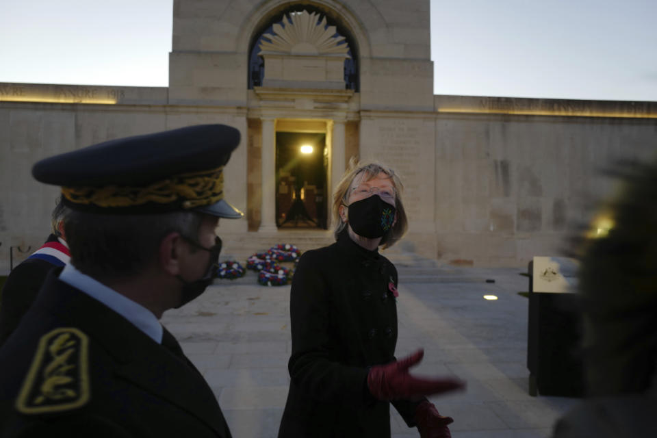 Australia's Ambassador to France Gillian Bird, right, talks with French authority after a wreath-laying ceremony at the Australian National Memorial in Villers-Bretonneux, northern France, on Anzac Day, Sunday, April 25, 2021. On another Anzac Day turned lonesome by the global pandemic, solitary actions show all the more how the sacrifices of Australia and New Zealand during World War I are far from forgotten. (AP Photo/Michel Spingler)