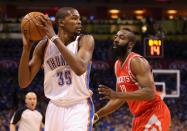 Kevin Durant (L) of the Oklahoma City Thunder is guarded by James Harden of the Houston Rockets on April 21, 2013. Durant scored 24 points with six rebounds and four assists in the Thunder's 120-91 rout