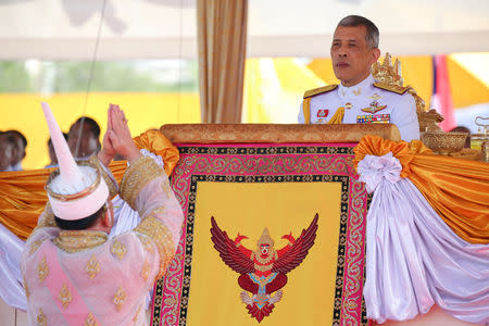 FILE PHOTO: Lertviroj Kowattana, permanent secretary of the Thai Ministry of Agriculture and Cooperatives, dressed in a traditional costume, greets Thailand's King Maha Vajiralongkorn during the annual Royal Ploughing Ceremony in central Bangkok, Thailand, May 14, 2018. REUTERS/Athit Perawongmetha/File Photo