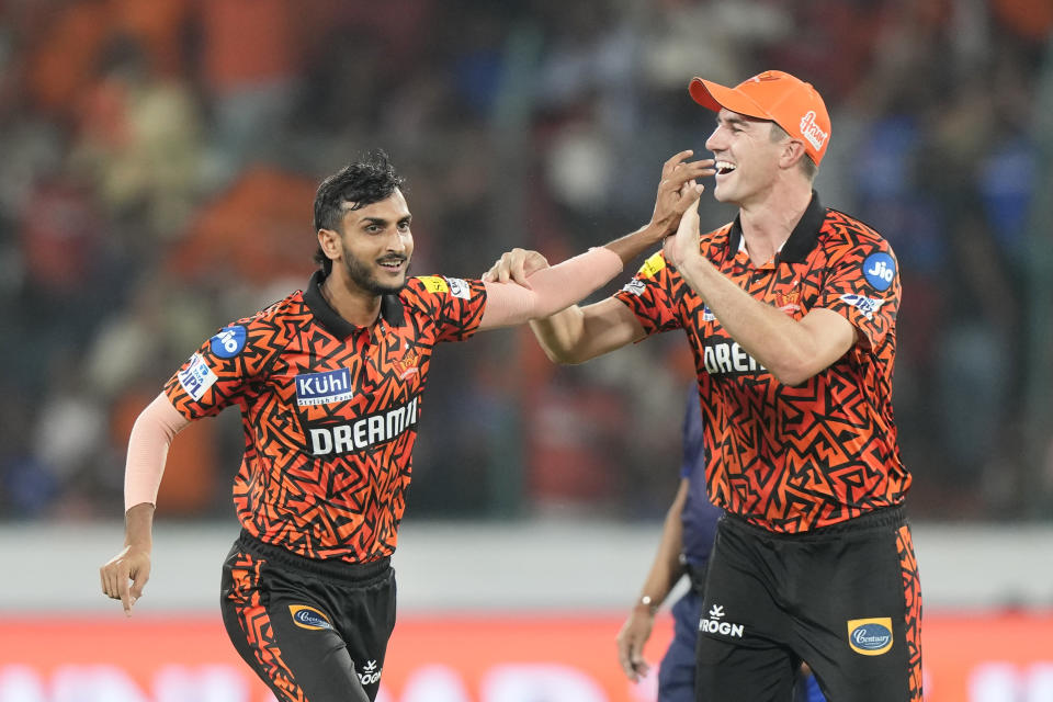 Sunrisers Hyderabad's captain Pat Cummins, right, and Shahbaz Ahmed celebrates the dismissal of Mumbai Indians' Ishan Kishan during the Indian Premier League cricket tournament between Sunrisers Hyderabad and Mumbai Indians in Hyderabad, India, Wednesday, March 27, 2024.(AP Photo/Mahesh Kumar A.)
