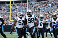 Carolina Panthers defensive end Marquis Haynes Sr. (98) runs off the field after he recovers a fumble and runs in for a touchdown during the first half of an NFL football game against the New Orleans Saints, Sunday, Sept. 25, 2022, in Charlotte, N.C. (AP Photo/Jacob Kupferman)