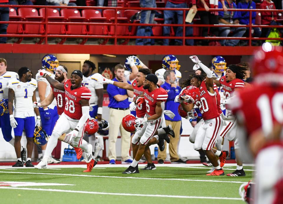 South Dakota football players run across the field after winning with a Hail Mary pass in their game against South Dakota State on Saturday, November 13, 2021, at the DakotaDome in Vermillion.