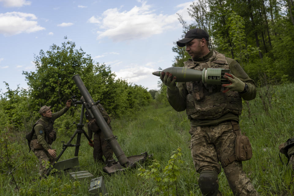 Ukrainian servicemen prepare to fire mortars towards Russian positions in east Kharkiv region, Ukraine, Tuesday, May 17, 2022. (AP Photo/Bernat Armangue)