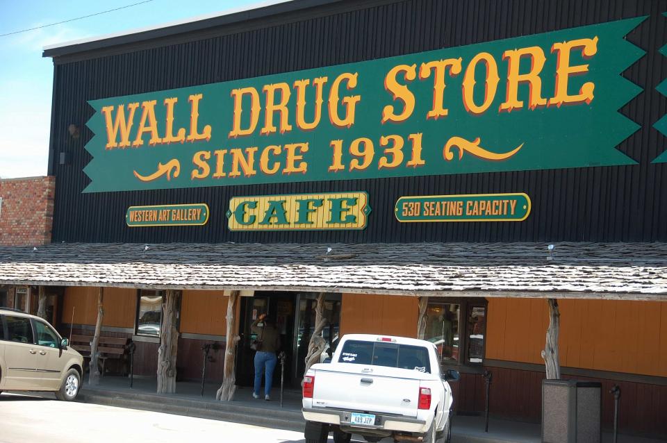 FILE - Ths file photo taken on May 6, 2009 shows the exterior of Wall Drug in Wall, S.D. Wall Drug is a sprawling attraction in the tiny town of Wall, South Dakota, with a drug store, gift shop, restaurants, a chapel and several other stores. Pharmacist Ted Hustead bought the drugstore in 1931, but business was slow until his wife suggested advertising free ice water to parched travelers. The water is still free to tourists enticed to stop here by signs on Interstate 90 on the cusp of the Black Hills. (AP Photo/Carson Walker, file)