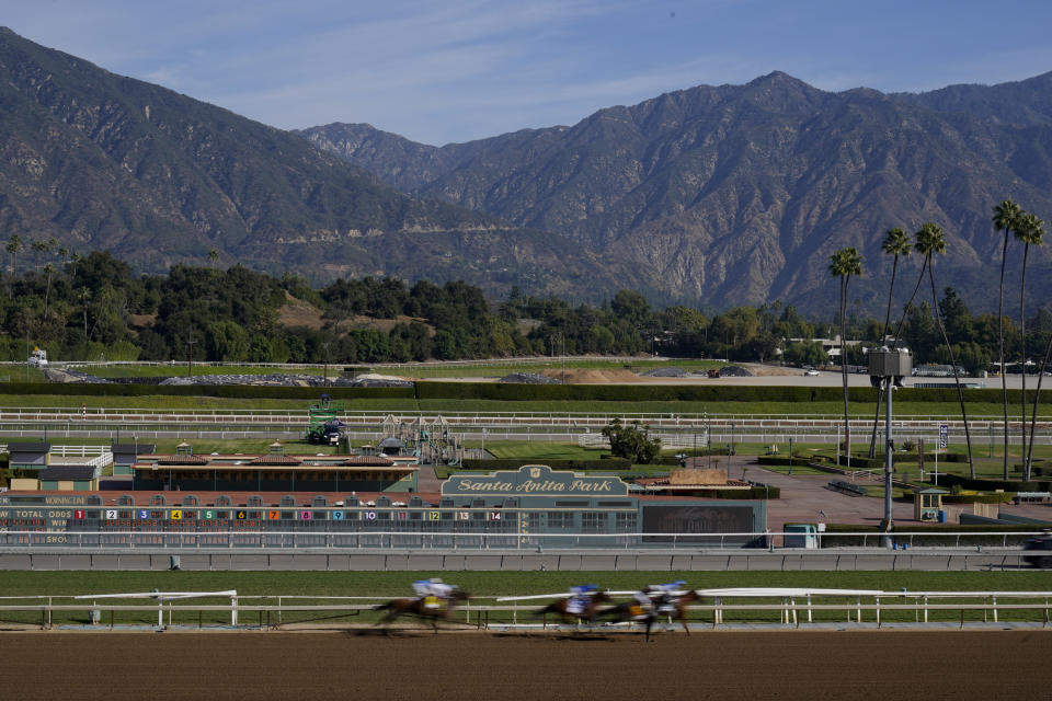 Horses and riders finish the first race during the second day of Breeder's Cup horse races Saturday, Nov. 4, 2023, at Santa Anita Park in Arcadia, Calif. The first race is not a Breeders' Cup Championship race. (AP Photo/Ashley Landis)