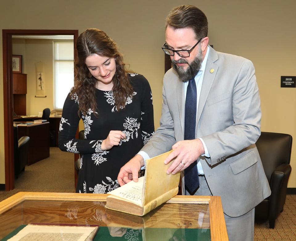 Honors College Coordinator Tatum Hochstetler and Assistant Dean Philip Phillips scan one of more than 20 rare books on loan from The Remnant Trust at Texas Tech University. The books and manscripts will be utilized by MTSU students in the spring Honors Lecture Series every Monday through April 4 and open to the public in the Paul W. Martin Sr. Honors Building Room 205 from 8 a.m. to 4:30 p.m. daily.