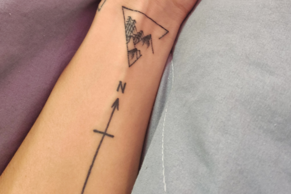 Cross tattoo representing the true north <p>Unsplash</p>