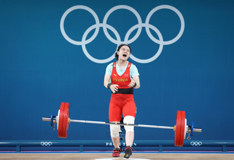 PARIS, FRANCE - AUGUST 08: Shifang Luo of Team People's Republic of China celebrates setting new Olympic Record of 134kg in a Clean & Jerk during the Weightlifting Women's 59kg on day thirteen of the Olympic Games Paris 2024 at South Paris Arena on August 08, 2024 in Paris, France. (Photo by Matthew Stockman/Getty Images)