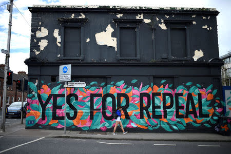 FILE PHOTO: A woman walks past a Pro-Choice mural on the side of a building ahead of a 25th May referendum on abortion law, in Dun Laoghaire, Ireland, May 7, 2018. Picture taken May 7, 2018. REUTERS/Clodagh Kilcoyne/File Photo