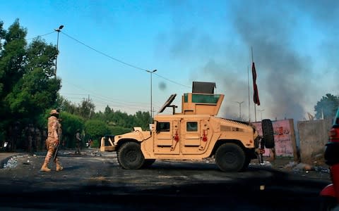 Protesters defied orders to stay off the streets, as well as the threat of tear gas and live rounds - Credit: Khalid Mohammed/AP