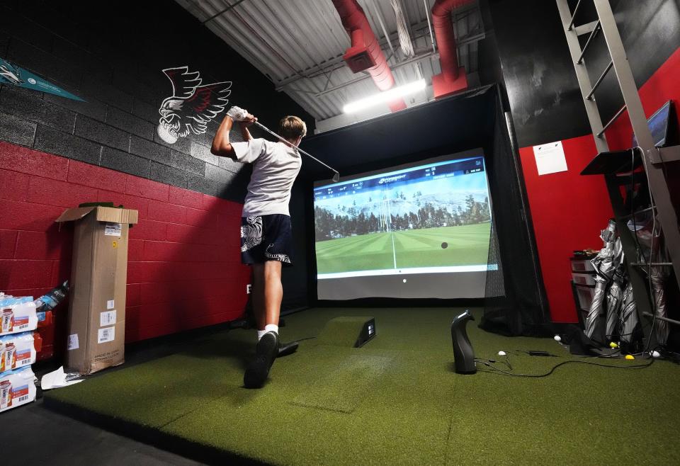 Williams Field senior Ben Carr works on his swing in the golf simulator room at Williams Field High School in Gilbert on Sept. 11, 2023.