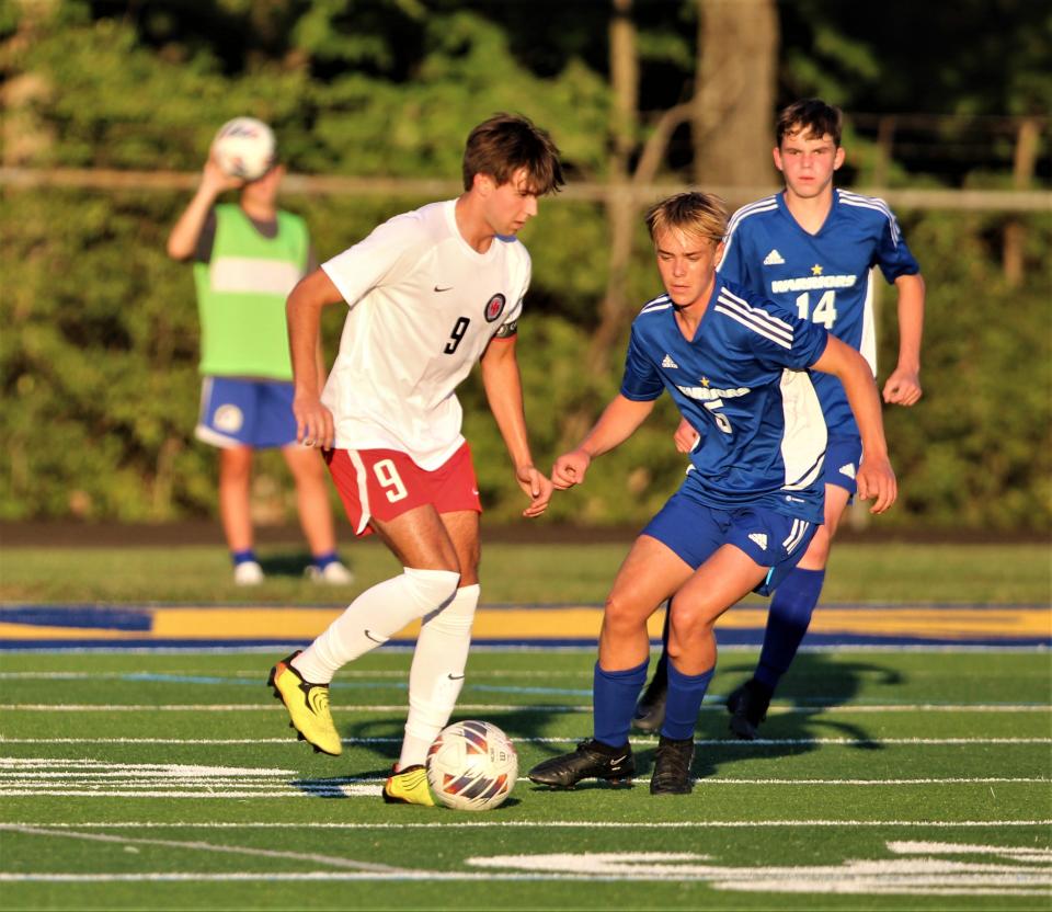 Mariemont player pressures Indian Hill senior Gavin Johnson (9) with the ball as Indian Hill defeated Mariemont.