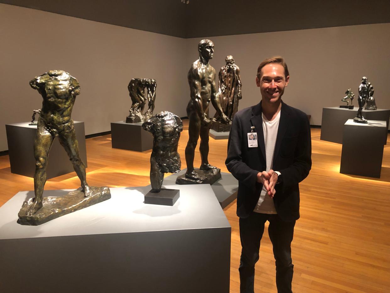 Alex Rich, Polk Museum of Art at Florida Southern College executive director and chief curator, with Rodin's sculptures "Study for the Torso of the Walking Man."