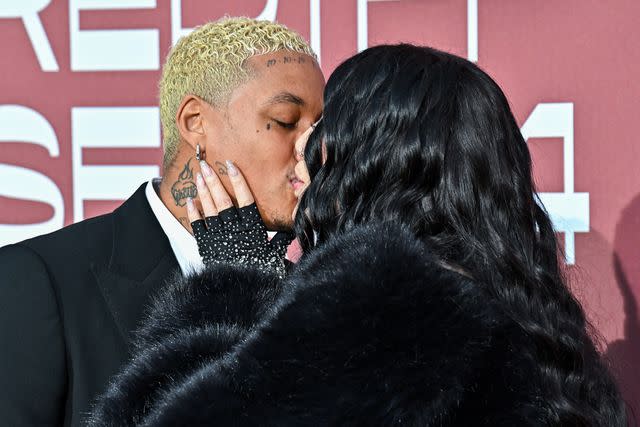 <p>Stephane Cardinale - Corbis/Corbis via Getty</p> Alexander Edwards and Cher kiss at the amfAR Gala Cannes 2024 on May 23, 2024