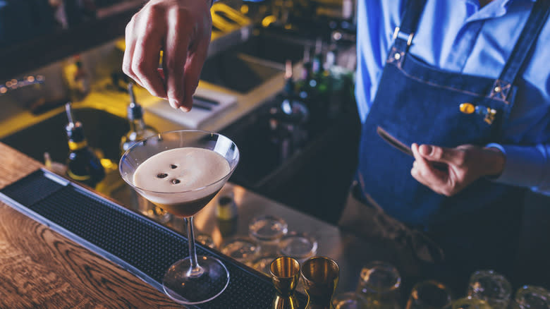 Bartender garnishing espresso martini