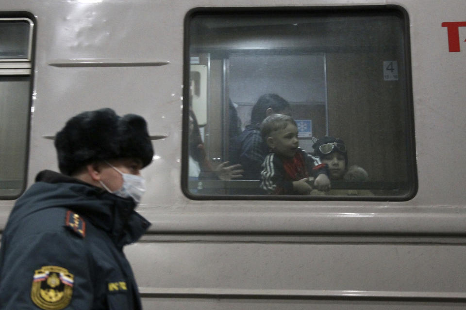 Children evacuated from the Donetsk region, the territory controlled by a pro-Russia separatist governments in eastern Ukraine, are seen through a train window as they wait to be taken to temporary housing, at the railway station in Nizhny Novgorod, Russia, Tuesday, Feb. 22, 2022. A long-feared Russian invasion of Ukraine appears to be imminent, if not already underway, with Russian President Vladimir Putin ordering forces into separatist regions of eastern Ukraine. (AP Photo/Roman Yarovitcyn)