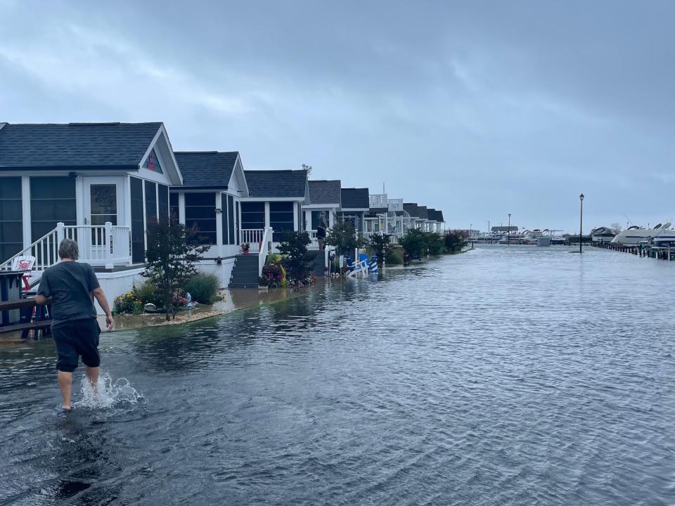 North Drive in West Bay Park was completely flooded as a person made the trek through the waters toward the tiny homes across from the bayside marina on Saturday, Sept. 23, 2023.