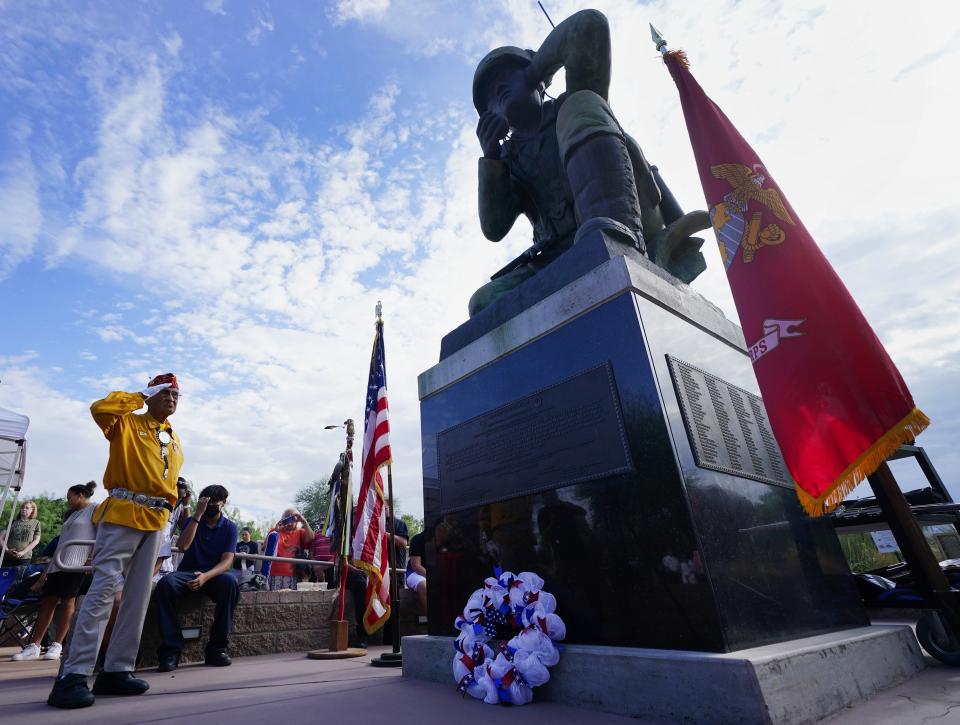 Navajo Code Talker Thomas Begay salutes at the Arizona Navajo Code Talkers statue memorial during a celebration for the Arizona State Navajo Code Talkers Day, Sunday, Aug. 14, 2022, in Phoenix. (AP Photo/Ross D. Franklin)