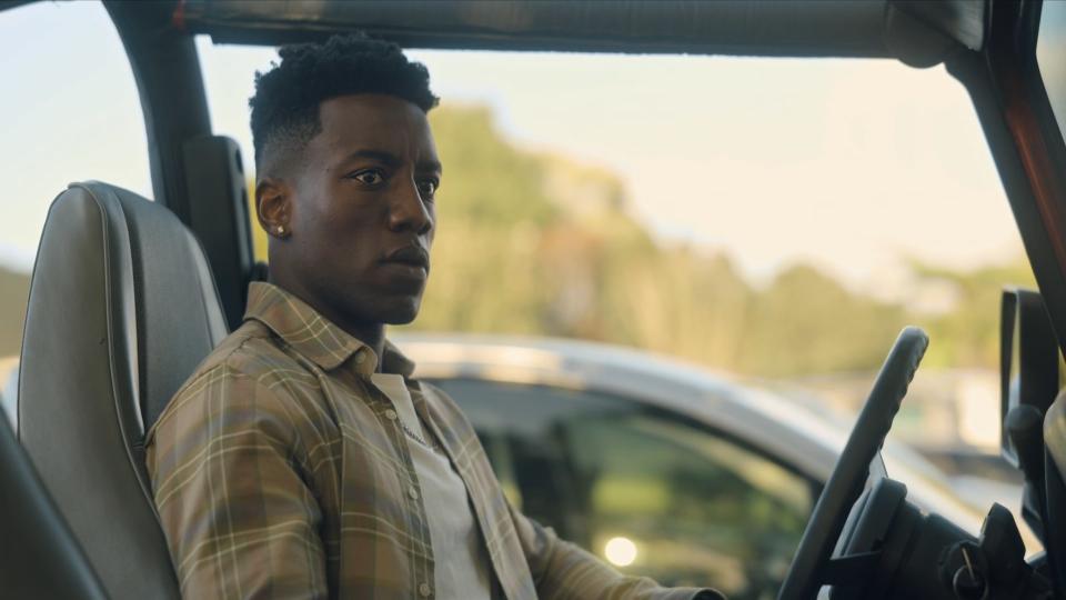 Chibuikem Uche sitting in the driver's seat of a car