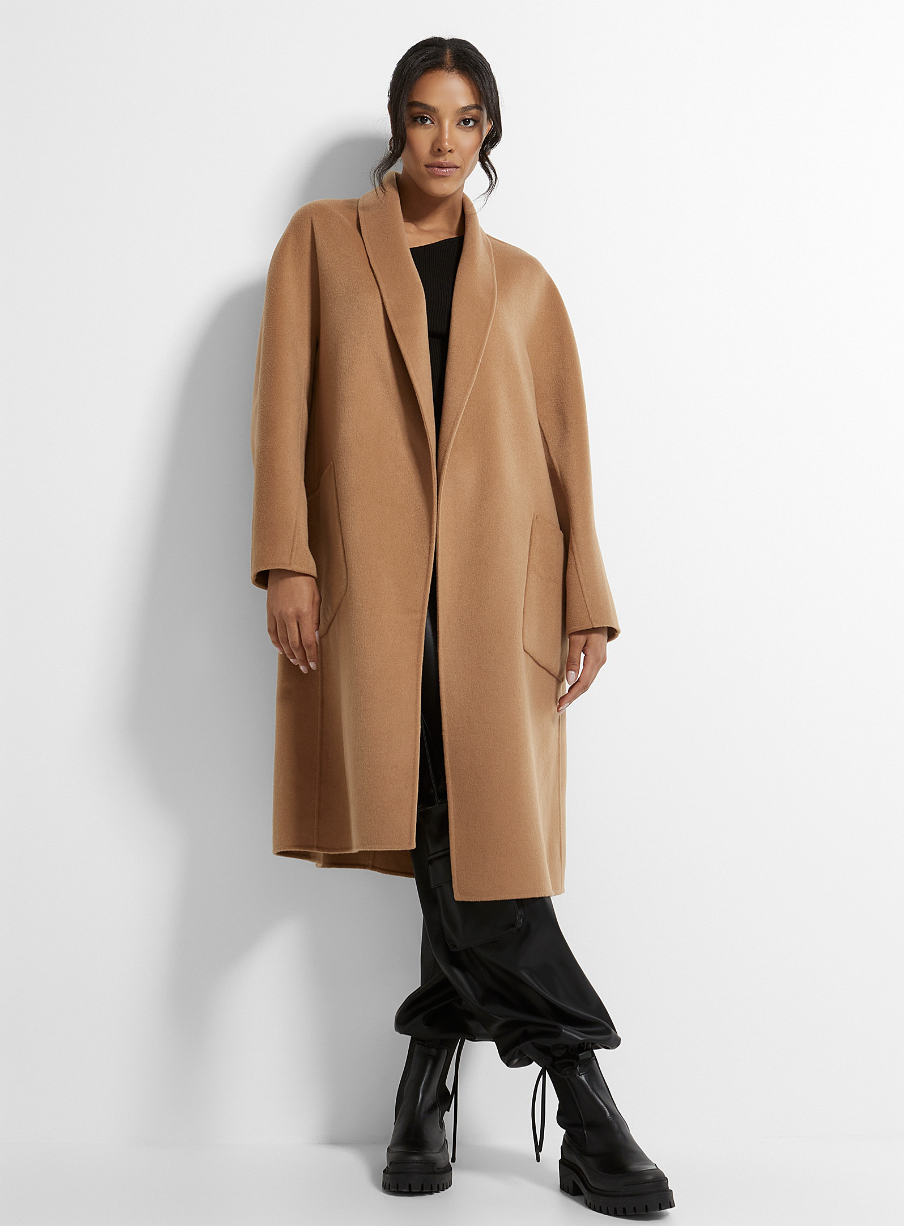 model wearing black combat boots, black pants and camel open Lamarque Thara Wool Coat in Light Brown (Photo via Simons)