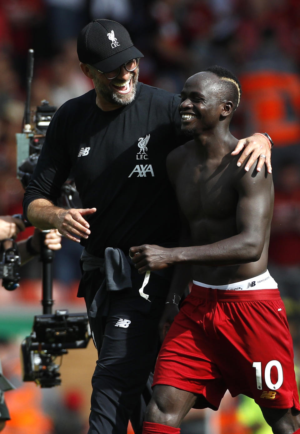 Liverpool's manager Jurgen Klopp, left, celebrates with Liverpool's Sadio Mane after the English Premier League soccer match between Liverpool and Newcastle at Anfield stadium in Liverpool, England, Saturday, Sept. 14, 2019. (AP Photo/Rui Vieira)