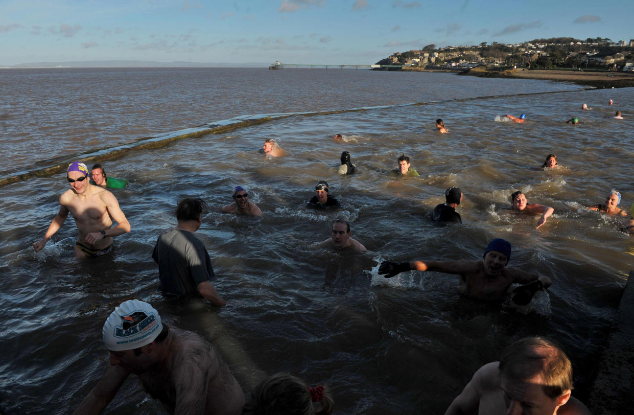 Swimmers dive in for the Annual New Year's Day swim at the Marine Swimming Lake in Clevedon, Somerset.   (Photo by Tim Ireland/PA Images via Getty Images)