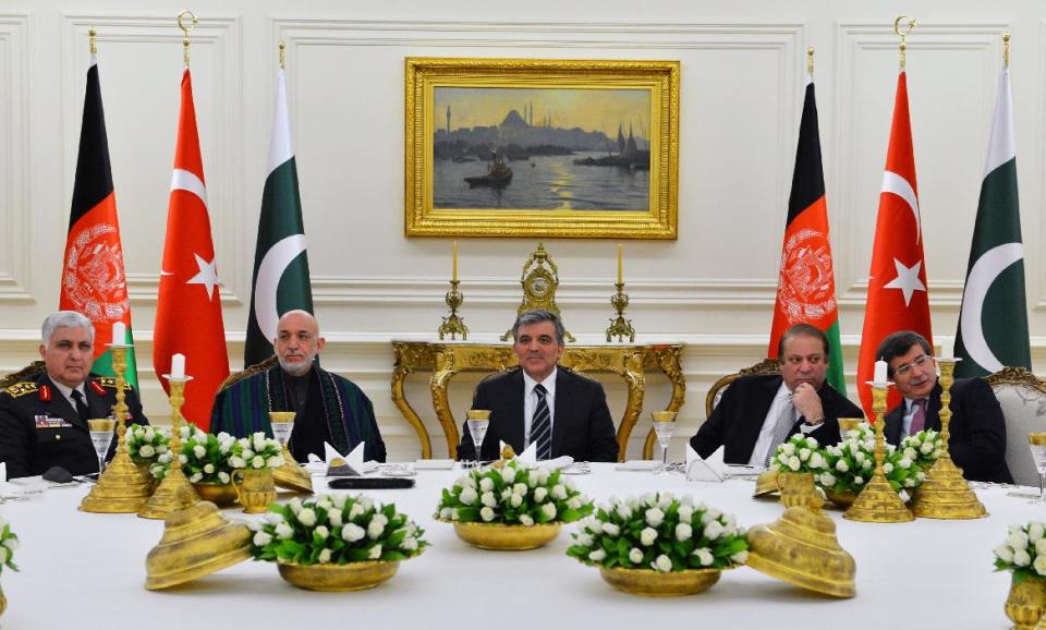 In this photo released by the Turkish Presidency Press Office, Turkish Abdullah Gul, center, Afghan President Hamid Karzai, second left, Pakistan Prime Minister Nawaz Sharif, second right, Turkish Chief of Staff Gen. Necdet Ozel, left, and Foreign Minister Ahmet Davutoglu, right, during a meeting in Ankara, Turkey, Thursday, Feb. 13, 2014. Karzai and Sharif are in Turkey for the 8th Afghanistan-Pakistan-Turkey Trilateral Summit.(AP Photo/Mustafa Oztartan, Turkish Presidency Press Office)