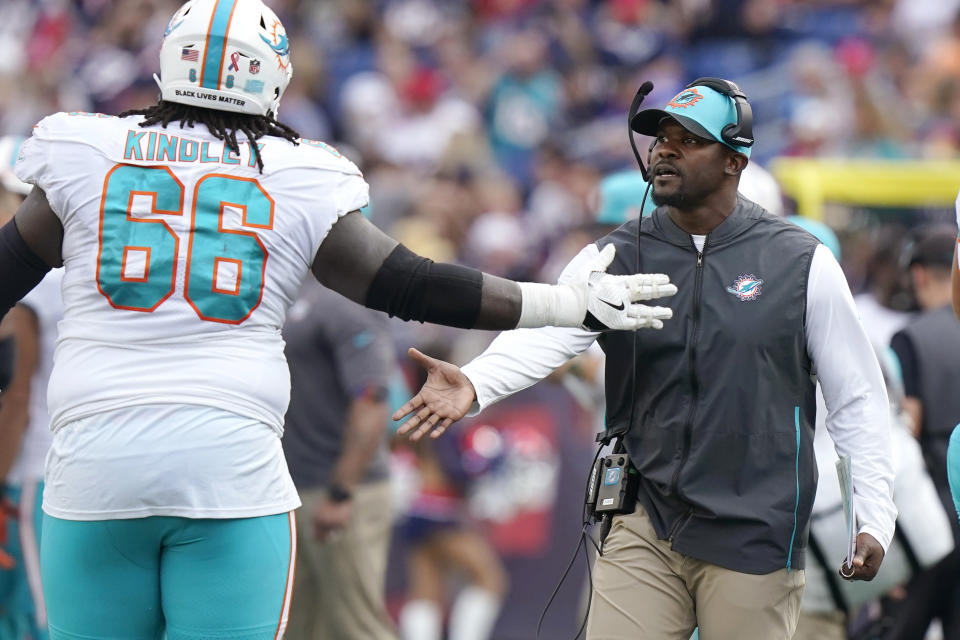 Miami Dolphins head coach Brian Flores, right, congratulates offensive guard Solomon Kindley (66) during the first half of an NFL football game against the New England Patriots, Sunday, Sept. 12, 2021, in Foxborough, Mass. (AP Photo/Steven Senne)