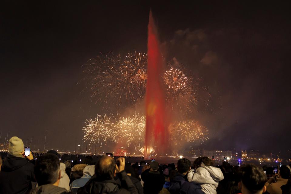 Fireworks illuminate the sky in bay of Geneva behind the famous water fountain “Le Jet d’Eau” during New Year celebrations in Geneva, Switzerland, Monday, 1 January2024 (AP)