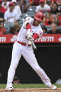 Los Angeles Angels designated hitter Shohei Ohtani hits into a fielder's choice during the first inning of a baseball game against the Seattle Mariners, Sunday, Sept. 26, 2021, in Anaheim, Calif. (AP Photo/Michael Owen Baker)