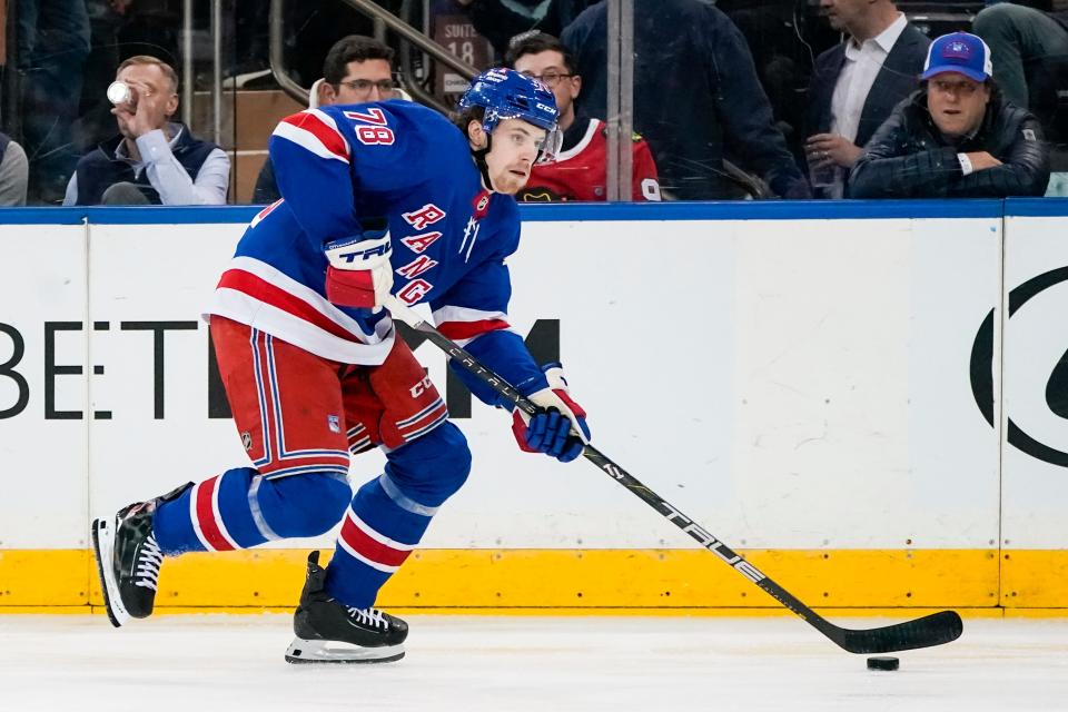 New York Rangers left wing Brennan Othmann (78) looks to pass the puck during the first period of an NHL hockey game against the Chicago Blackhawks in New York, Thursday, Jan. 4, 2024.