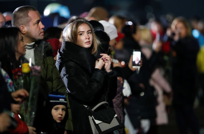 Relatives of Ukrainian citizens exchanged during a prisoners of war swap wait before a welcoming ceremony outside Kiev