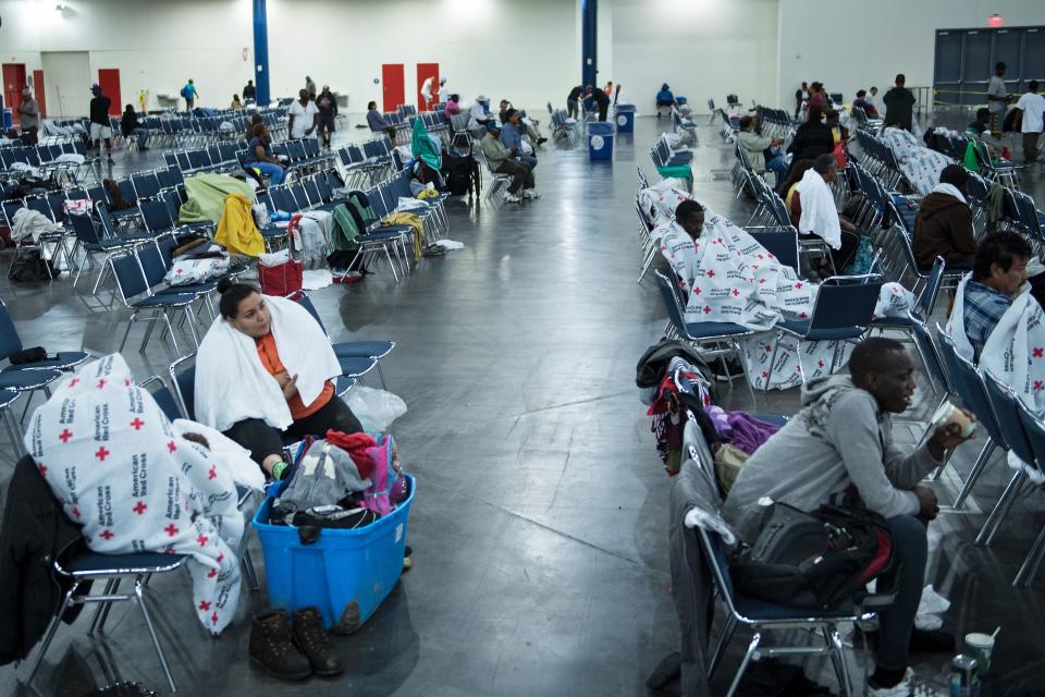 <p>Flood victims rest at a shelter in the George R. Brown Convention Center during the aftermath of Hurricane Harvey on Aug. 28, 2017 in Houston, Texas. (Photo: Brendan Smialowski/AFP/Getty Images) </p>