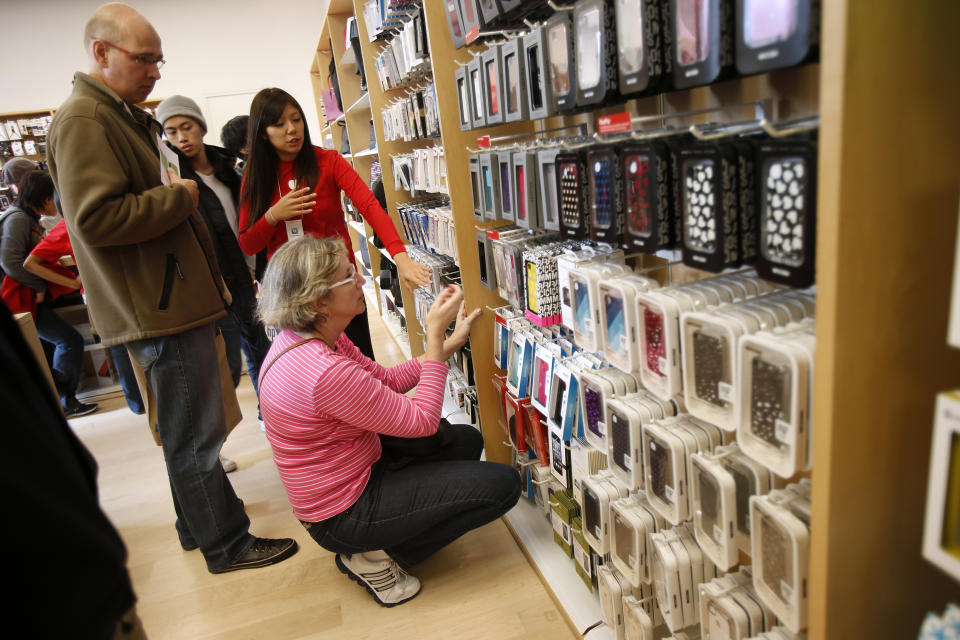 A holiday shopper shops for iPhone accessories at the Apple Store during Black Friday in San Francisco, California, November 23, 2012. Black Friday, the day following the Thanksgiving Day holiday, has traditionally been the busiest shopping day in the United States. REUTERS/Stephen Lam (UNITED STATES - Tags: BUSINESS)