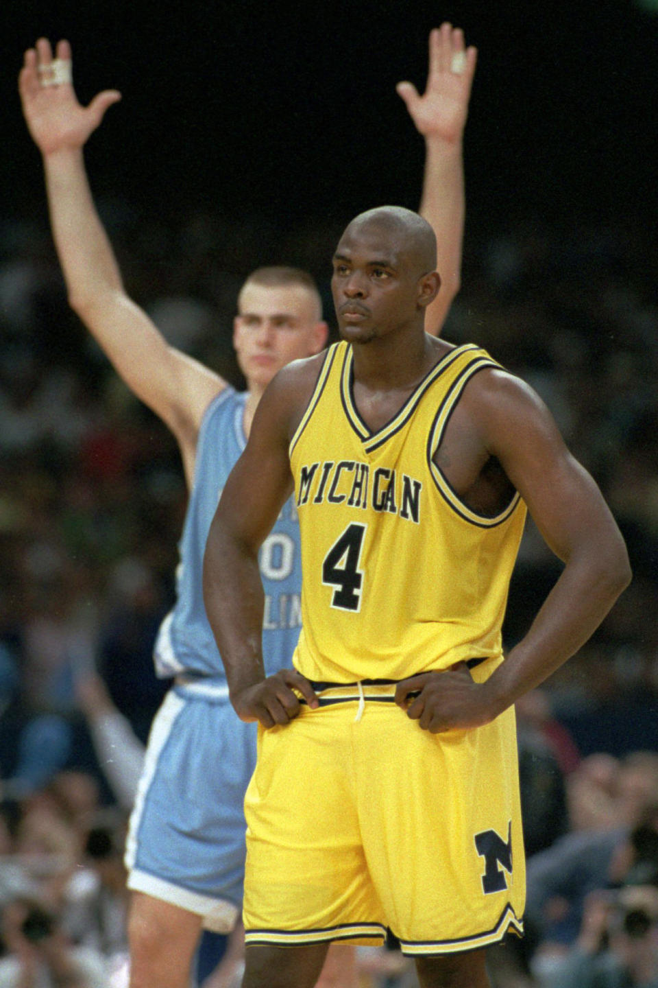 FILE - Michigan's Chris Webber (4) stands by as North Carolina's Eric Montross celebrates during North Carolina's technical foul shots in the final seconds of the NCAA Final Four championship game at the Superdome in New Orleans, April 5, 1993. North Carolina won the national title 77-71. (AP Photo/Susan Ragan, File)