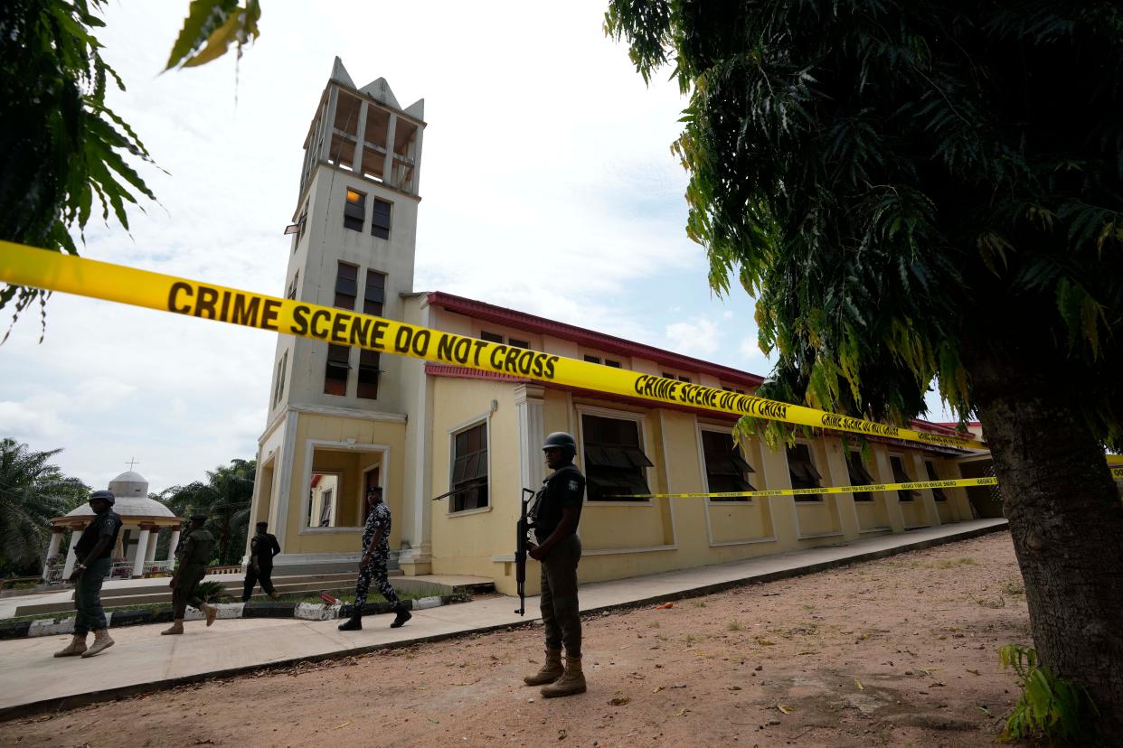 Nigerian police stand guard outside of the St. Francis Catholic church in Owo, Nigeria, Monday, June 6, 2022 a day after an attack that targeted worshipers. The gunmen who killed 50 people at a Catholic church in southwestern Nigeria opened fire on worshippers both inside and outside the building in a coordinated attack before escaping the scene, authorities and witnesses said Monday. (AP Photo/Sunday Alamba) ORG XMIT: XSA125