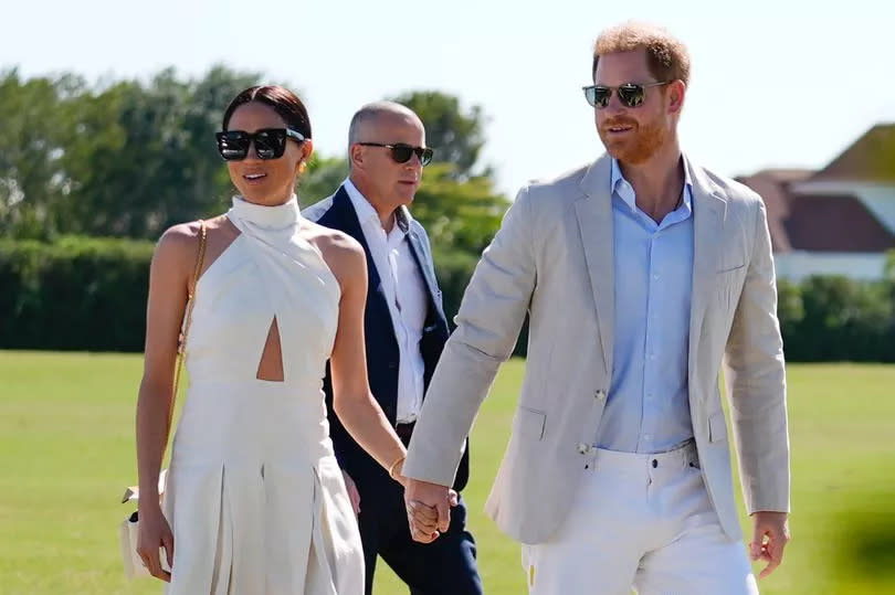 Britain's Prince Harry, right, and wife Meghan Markle, Duchess of Sussex, arrive for the 2024 Royal Salute Polo Challenge to Benefit Sentebale, Friday, April 12, 2024, in Wellington