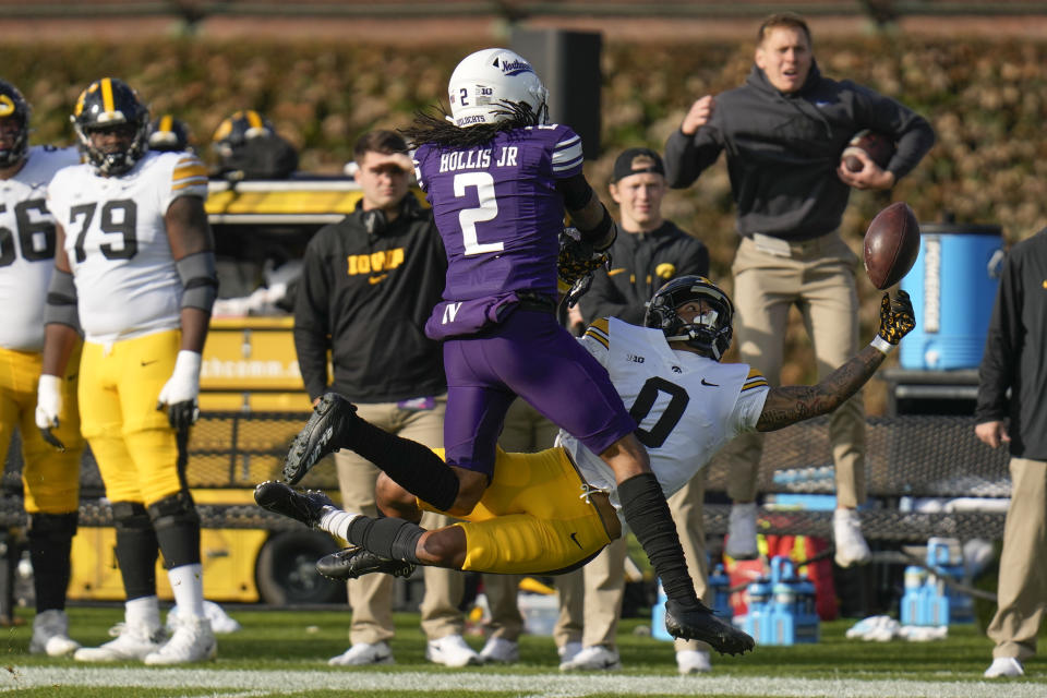 Northwestern defensive back Garnett Hollis Jr. (2) blocks a pass intended for Iowa wide receiver Diante Vines (0) during the first half of an NCAA college football game Saturday, Nov. 4, 2023, at Wrigley Field in Chicago. (AP Photo/Erin Hooley)