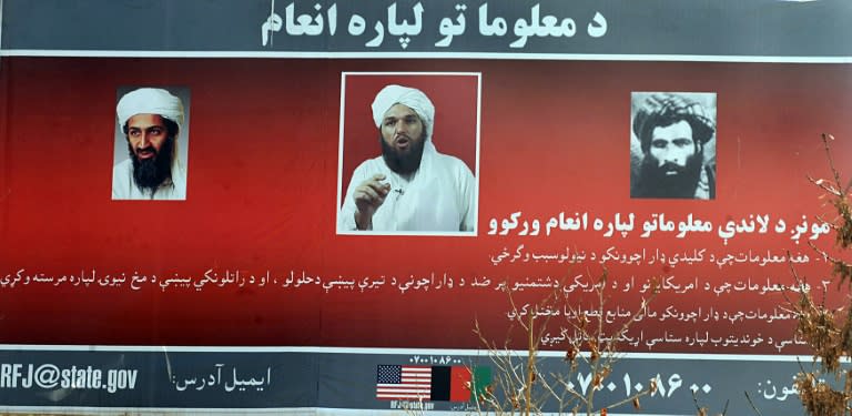 A billboard displays the photos of (L-R) Al-Qaeda mastermind Osama bin Laden, Adam Gadhan, an American-born radical in charge of Al-Qaeda propaganda, and former Taliban leader Mullah Mohammad Omar