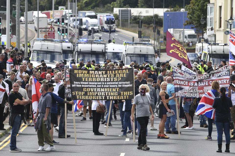 Anti-migrant protesters demonstrate against immigration and the journeys made by refugees crossing the Channel to Kent, in Dover, England, Saturday, Sept. 5, 2020. Police controlled a small scale demonstration against immigration, calling for authorities to do more to protect English shores, at England's southern port city nearest to mainland Europe. (Stefan Rousseau/PAvia AP)