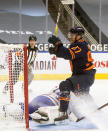 Edmonton Oilers' Connor McDavid (97) celebrates his goal on Montreal Canadiens' goalie Jake Allen (34) during the second period of an NHL hockey game, Wednesday, April 21, 2021 in Edmonton, Alberta. (Jason Franson/The Canadian Press via AP)