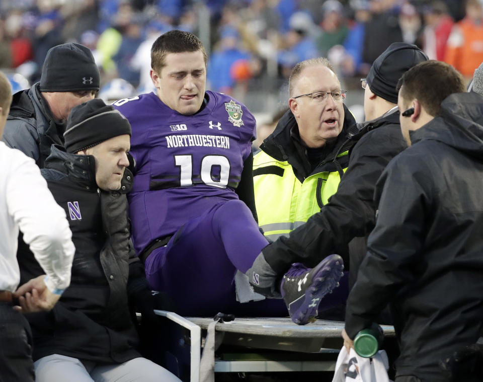 Northwestern quarterback Clayton Thorson (18) is put on a cart to be taken off the field after being injured in the first half of the Music City Bowl NCAA college football game against Kentucky, Friday, Dec. 29, 2017, in Nashville, Tenn. (AP Photo/Mark Humphrey)